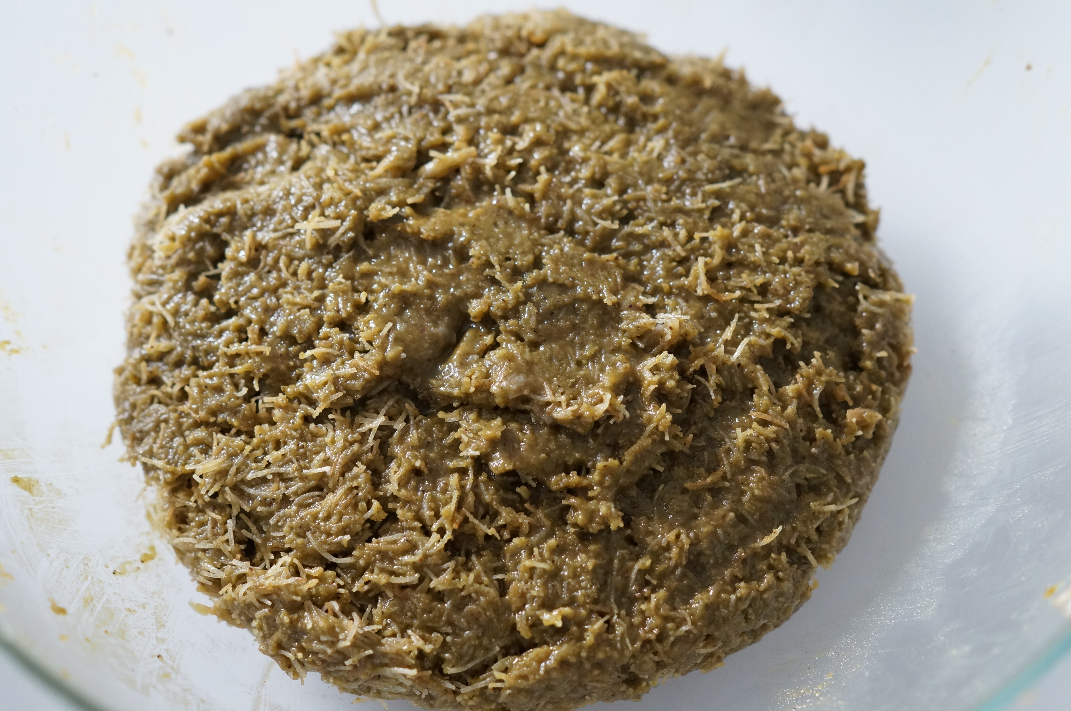 Combined pistachio paste and kataifi mixture in a bowl